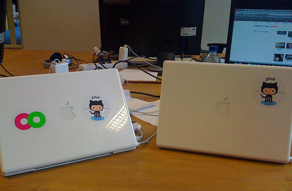 GitHub octocat logo stickers on MacBook